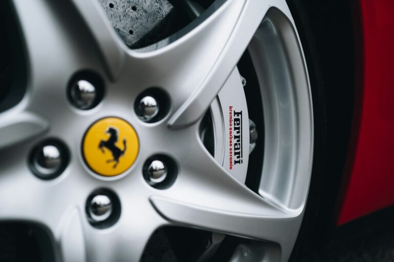 Close-up of a silver ferrari car wheel and brake.